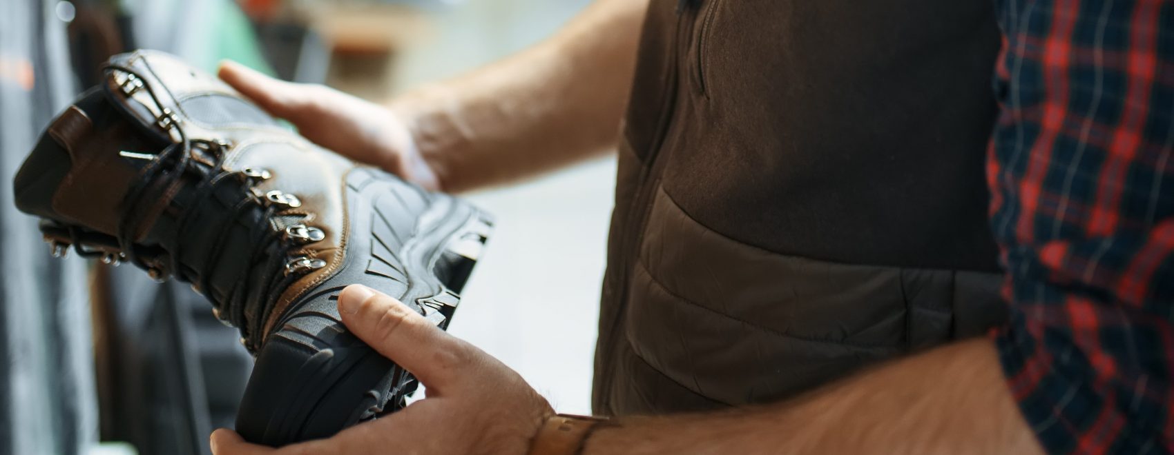 Image of man choosing footwear boots