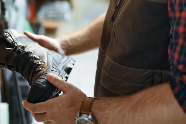 Image of man choosing footwear boots